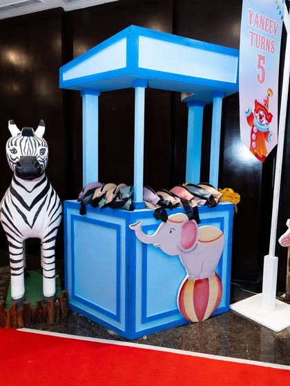 A carnival game booth with a zebra prop, ready for guests to play and win prizes.