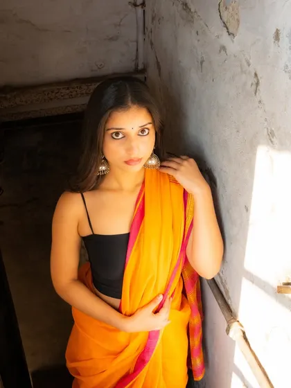 This shot uses the window frame and natural light to create a beautifully lit, intimate portrait.