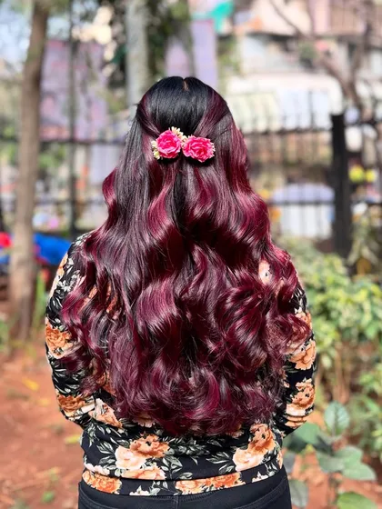 The floral accessories add a perfect finishing touch to this stunning wine red hair color.