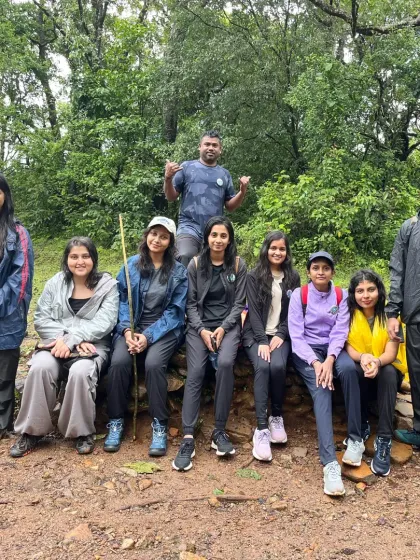 A small group taking a rest on a stone wall along the trail. Every part of the journey is an opportunity for a photo.