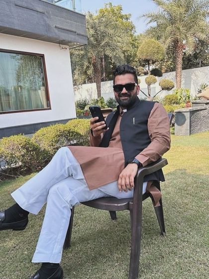 Relaxing in a garden chair, dressed in a traditional kurta. Life is a journey, and I have faith that my destination will emerge from the dust of my footsteps.