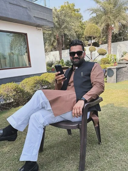 Relaxing in a garden chair, dressed in a traditional kurta. Life is a journey, and I have faith that my destination will emerge from the dust of my footsteps.