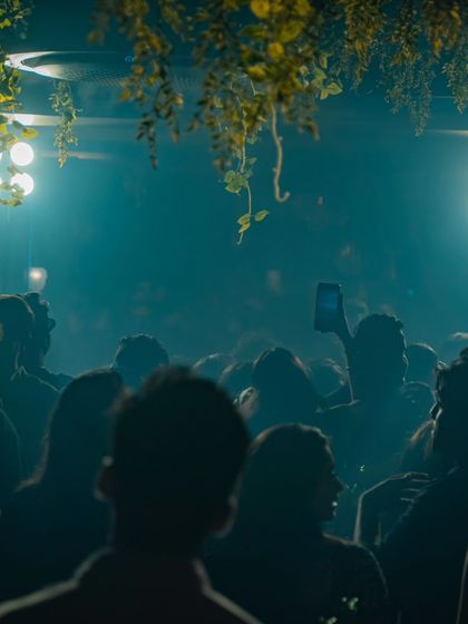 A smoky, atmospheric shot of the crowd at a club in Thane. The energy is almost tangible.