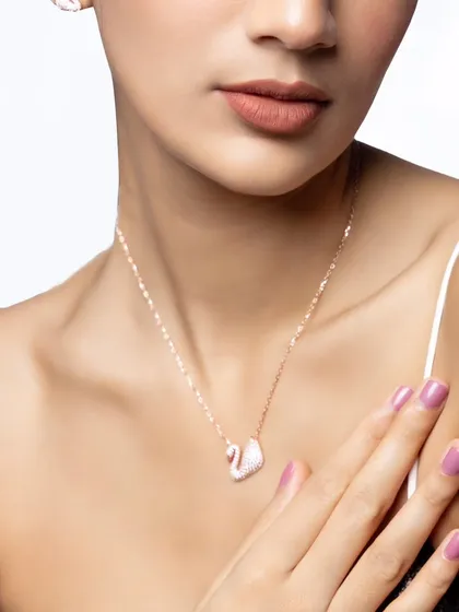 A detailed close-up of the swan necklace from Nutan Jewellers. This product-focused shot highlights the craftsmanship and delicate design of the jewelry piece.