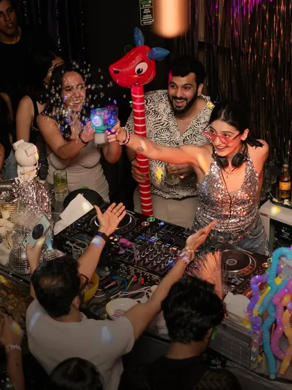 It's not a ParaDisco party without some fun props. Here I am interacting with the crowd, handing out bubble guns and balloon animals to keep the playful energy going all night.