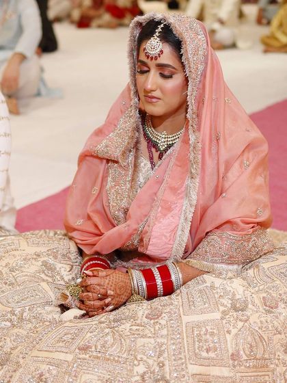 A candid moment during the ceremony, showcasing the timeless and elegant quality of this minimal yet magical peach bridal look.