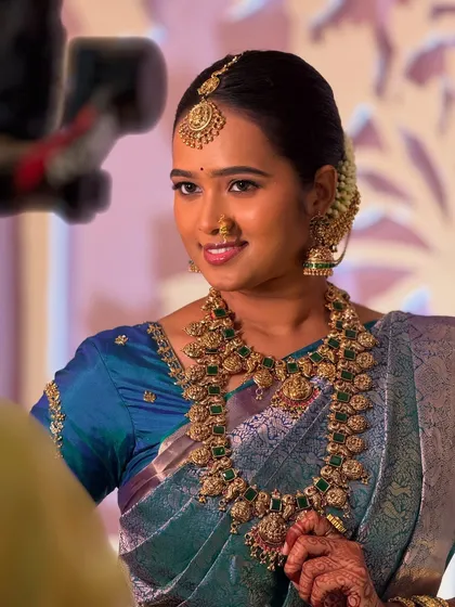 This is a complete raw picture of my beautiful bride Swathy from Chidambaram. Her subtle Muhurtham makeup allows her natural glow to shine through, perfectly paired with antique gold jewellery and a classic bridal updo.