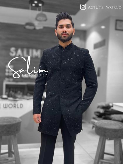 A sleek, longline black Indo-Western jacket. The subtle shimmer comes from scattered black sequins hand-stitched all over the garment, creating a sophisticated look for an evening affair.