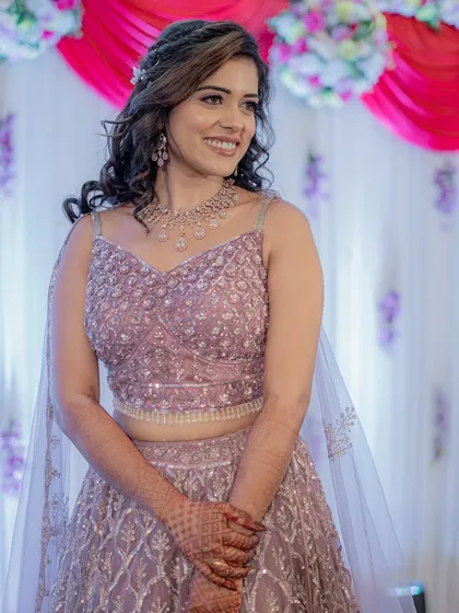 A beautiful portrait of the bride in her lilac sangeet lehenga, her makeup is minimal and fresh.
