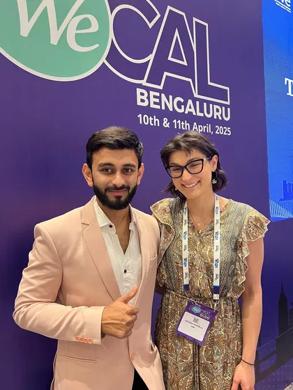 Connecting with speakers and attendees is a key part of my hosting style. This was a great moment with a guest at the We Local conference in Bengaluru, making everyone feel included.