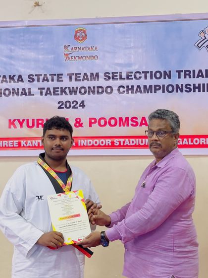 Our coach presenting a certificate to a gold medalist at the Karnataka State Championship selection trials. We secured 14 gold medals in total, with all winners heading to the nationals.