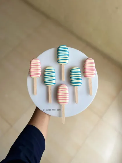Pink and blue cakesicles, perfect for a baby shower or gender reveal party. They are a delicious and fun alternative to cake slices.