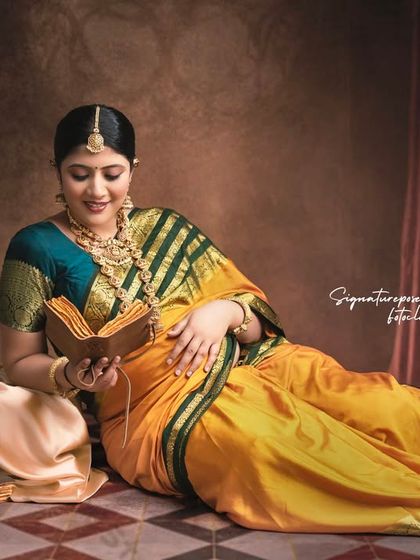 A royal-themed portrait with the mother-to-be reading, set against a rich, textured backdrop for a regal feel.