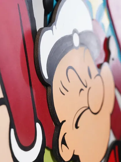 A close-up shot of the Popeye 3D artwork, showing the clean lines and crisp edges of the layered wood cutouts. Every detail is hand-painted with markers and spray paint.