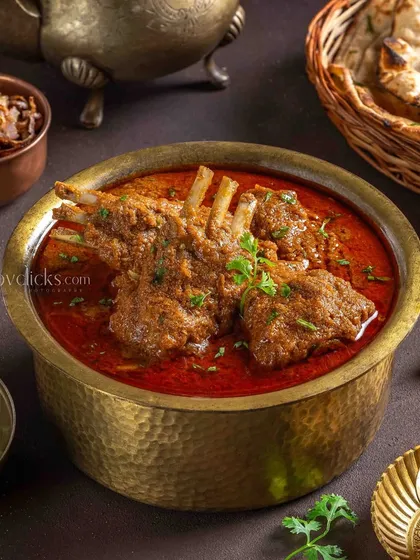 Mutton Rara, a specialty dish for The Mughal House. The rich, dark gravy and prominent bone-in pieces are styled to look intensely flavorful and satisfying.