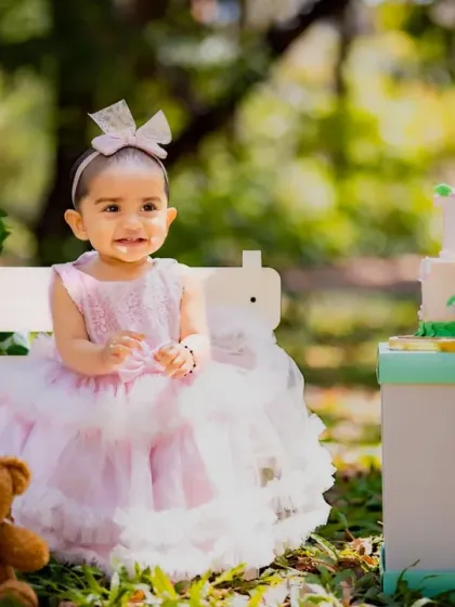 A little princess with her birthday cake in the park. Outdoor cake smashes are a fun and beautiful option.