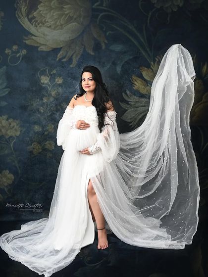 A stunning portrait with a flowing veil. The sheer fabric adds a touch of bridal-inspired elegance and drama to this beautiful white gown shot.