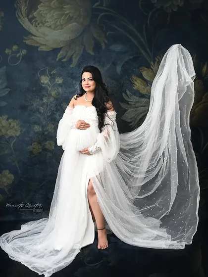 A stunning portrait with a flowing veil. The sheer fabric adds a touch of bridal-inspired elegance and drama to this beautiful white gown shot.