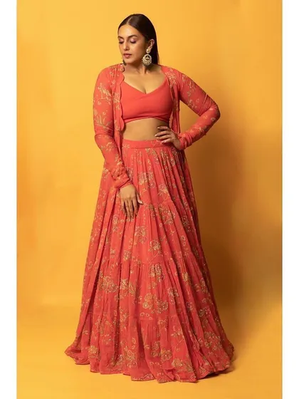 This printed orange lehenga set by Paulmi and Harsh is a vibrant and modern take on traditional wear. The matching jacket adds a contemporary layer, perfect for a daytime event.