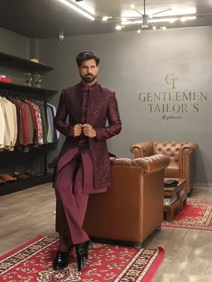 This wine-colored Indo-western ensemble, featuring a sequined long jacket over a matching kurta and trousers, exemplifies our approach to modern celebratory wear. Photographed in our studio, it showcases the sharp tailoring and luxurious feel of our creations.