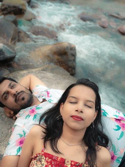 An artistic overhead shot of the couple lying by the river, creating a unique and intimate pre-wedding portrait.