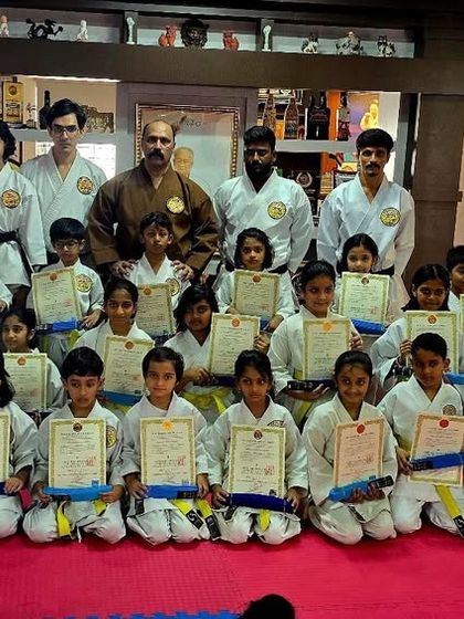 A group of our young students proudly holding their new belts and certificates after a successful karate belt test. This moment marks a significant step forward in their martial arts journey.