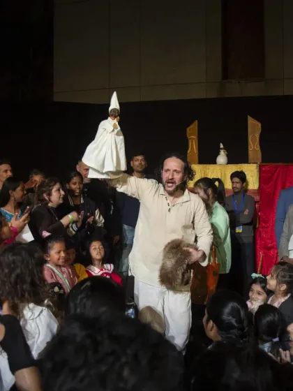 The puppeteer of 'Io, Pulcinella' brings Italy's most celebrated puppet character into the audience. This interactive moment allows children and adults to see the famous Pulcinella hand puppet up close.