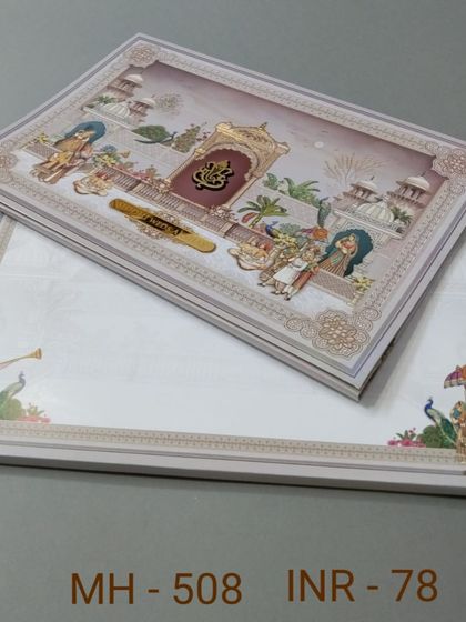 This invitation features a detailed illustration of a traditional ceremony with a Ganesha emblem. The design is rich in cultural motifs and perfect for a classic wedding.