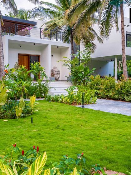The entrance to a luxury villa I designed, featuring a serene Buddha statue and lush landscaping. My designs focus on creating a tranquil and welcoming atmosphere from the moment you arrive.
