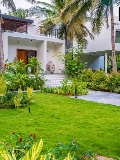 The entrance to a luxury villa I designed, featuring a serene Buddha statue and lush landscaping. My designs focus on creating a tranquil and welcoming atmosphere from the moment you arrive.