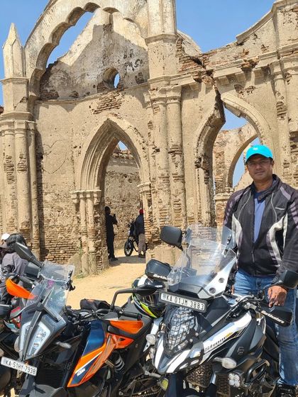 A rider posing with his adventure tourer bike in front of the historic Shettihalli Rosary Church. Our rides often blend adventure with exploring unique architectural and historical sites.