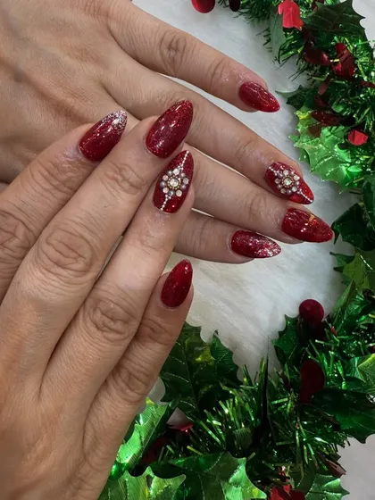 Perfect for the festive season or a glamorous party. These deep red almond nails feature intricate, hand-placed diamond stones that catch the light beautifully.