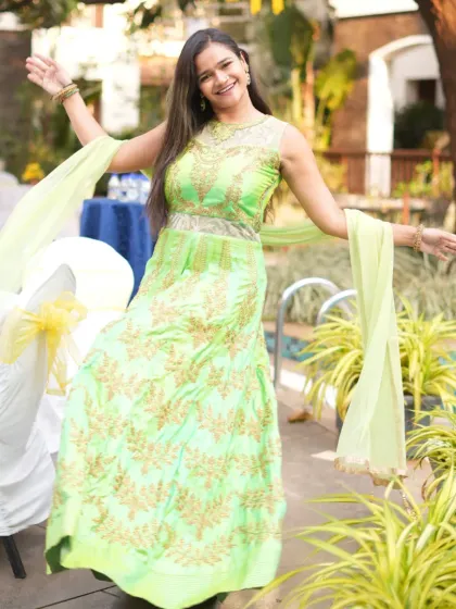 A joyful, open-armed pose that captures the spirit of the celebration.