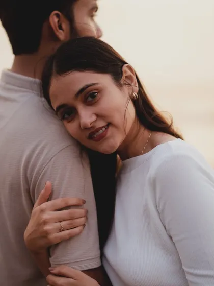 A beautifully intimate portrait from a Mumbai pre-wedding shoot. The soft focus and her peaceful expression as she rests on his shoulder create a feeling of trust and serenity.