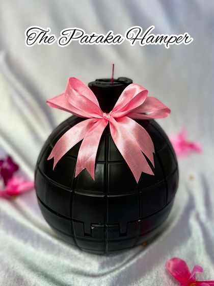 This is the "Pataka Hamper," a unique bomb-shaped gift box. It's a playful and dramatic way to present a surprise gift inside for your 'pataka' sister.