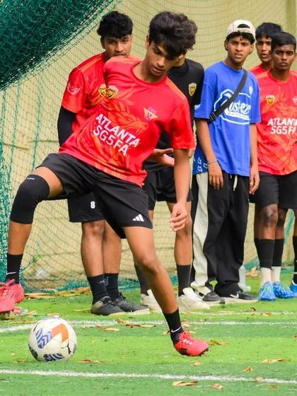 A U15 player preparing to take a free kick, showcasing focus and technique.