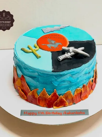 A Percy Jackson theme cake for an 11th birthday. The design incorporates symbols from the book series, like the Camp Half-Blood logo and Poseidon's trident, all made with minimal fondant.