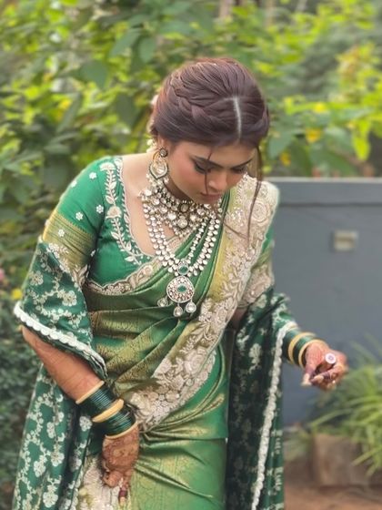 A portrait of the bride, showing the front view of her braided hairstyle. The soft twists at the front add a modern touch to the traditional braid.