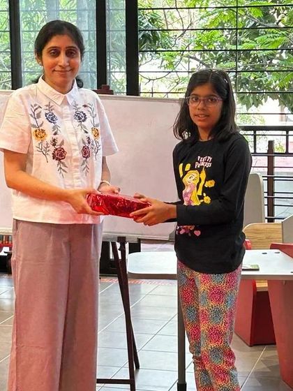 Another proud winner receiving her prize. A huge shout-out to all our participants, you are all winners for your love of reading!