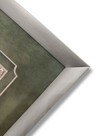 A corner detail of the Kyoto silver metal frame. The brushed metal finish provides a modern contrast to the traditional silver plaque and the soft texture of the suede matting.