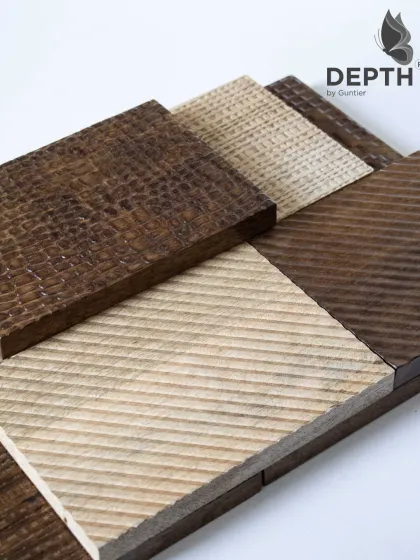 This selection of textured veneer samples highlights the contrast between dark and light woods, as well as different carving styles like diagonal and cross-hatch patterns.