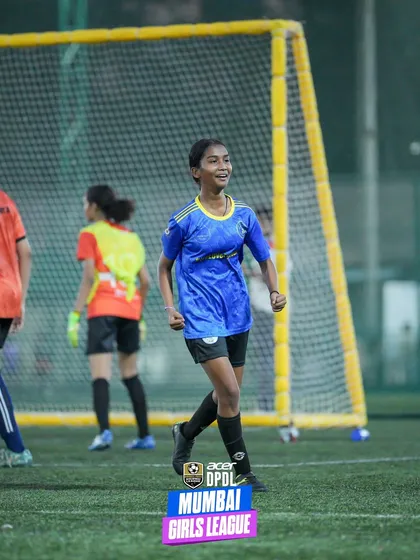 A player smiles with satisfaction after a successful play during a match. This photo captures the joy and confidence that comes from competing and performing well on the pitch.