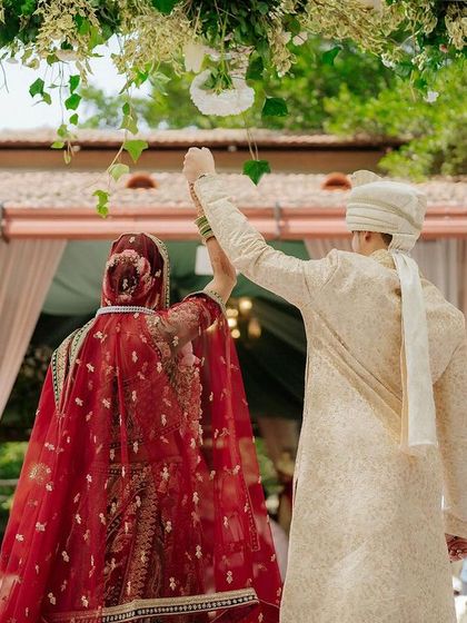A beautiful moment from behind as the couple raises their hands in celebration after the completion of their vows.