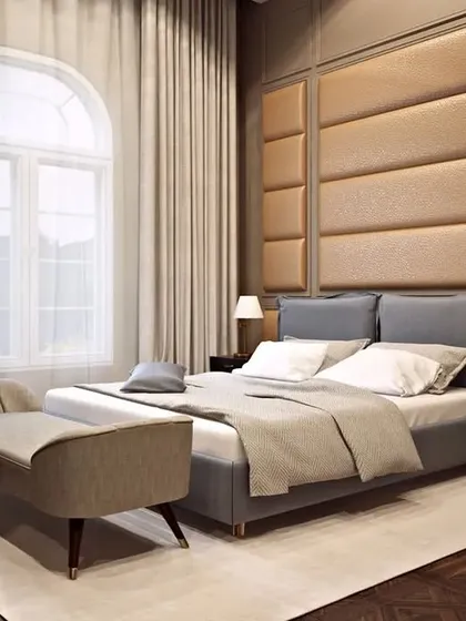 A master bedroom suite in our Chattarpur bungalow project, blending comfort with classic design. The room features a custom upholstered headboard, elegant wall paneling, and arched windows, reflecting a cohesive luxury design language throughout the home.