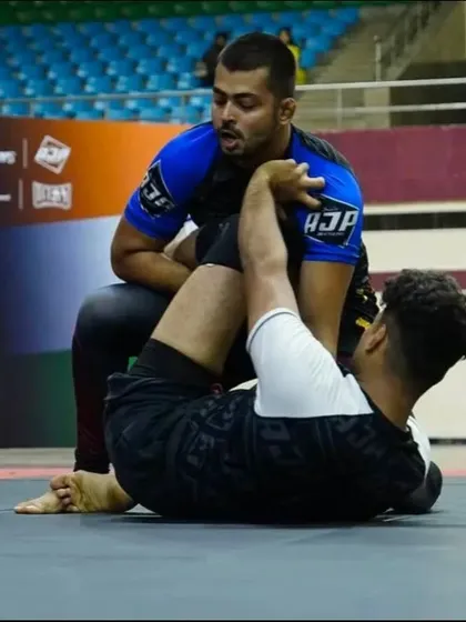 A grappling competition in action. Our fighter is on the bottom, working his guard, a testament to the endless process of improvement in Jiu-Jitsu.