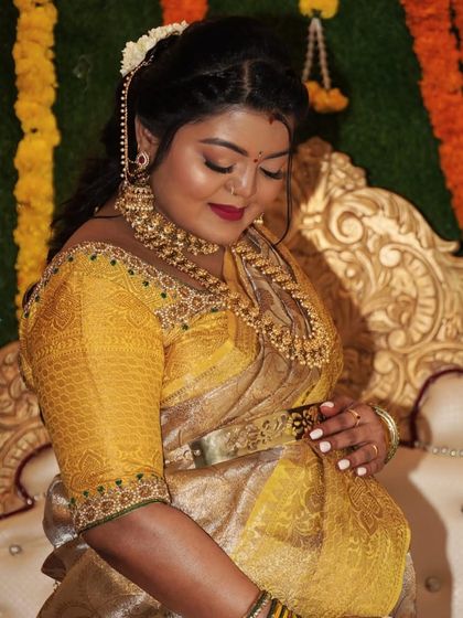 A beautiful candid of the mom-to-be during her baby shower. The makeup highlights her features with a soft glam finish and a classic red lip.