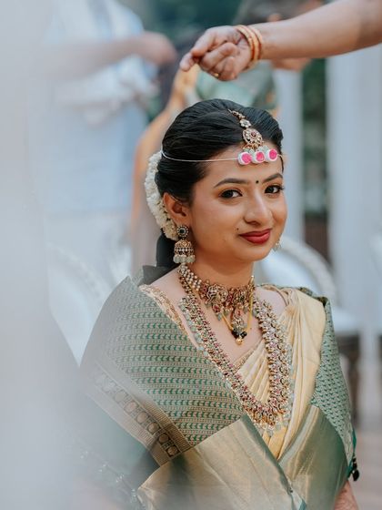 A close-up during the ceremony, her makeup looking radiant and her expression serene.