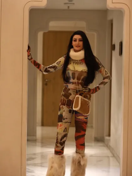 The Yeti-inspired outfit in a hallway shot, showing how the look works in a different environment. The printed catsuit is a piece of wearable art, styled to be both edgy and chic.