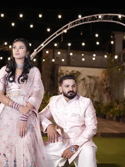 A stunning portrait of a couple during their evening reception, with the romantic glow of our string lights in the background.