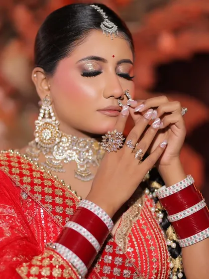 A beautiful pose showing the intricate details of the bridal look, from the nails to the nath and the perfectly blended makeup.